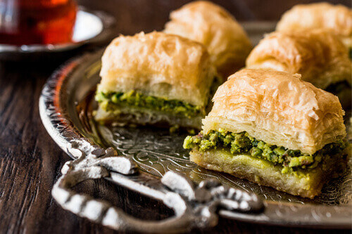 Baklava: A Jordanian dessert made with layers of filo pastry, nuts, and syrup, served as a sweet treat in markets and bakeries.