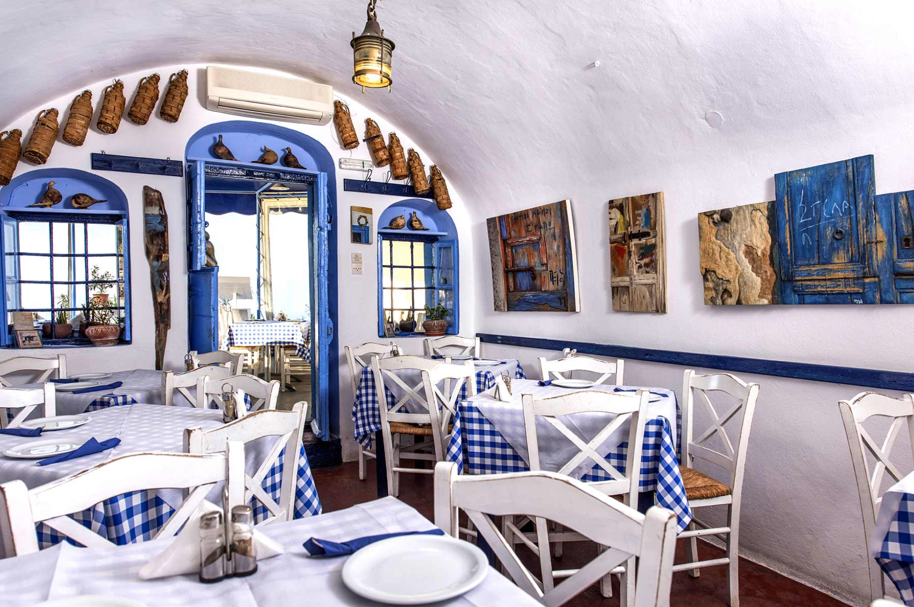 Dining tables at Aktaion Taverna in Firostefani, a historic family-run restaurant serving Santorini cuisine