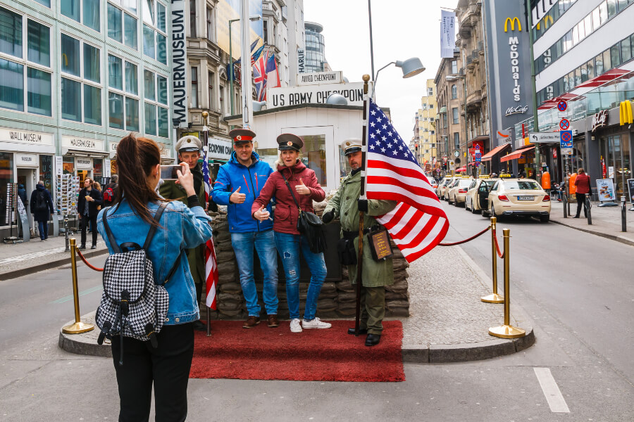 Tourists taking photos on the street at Checkpoint Charlie.