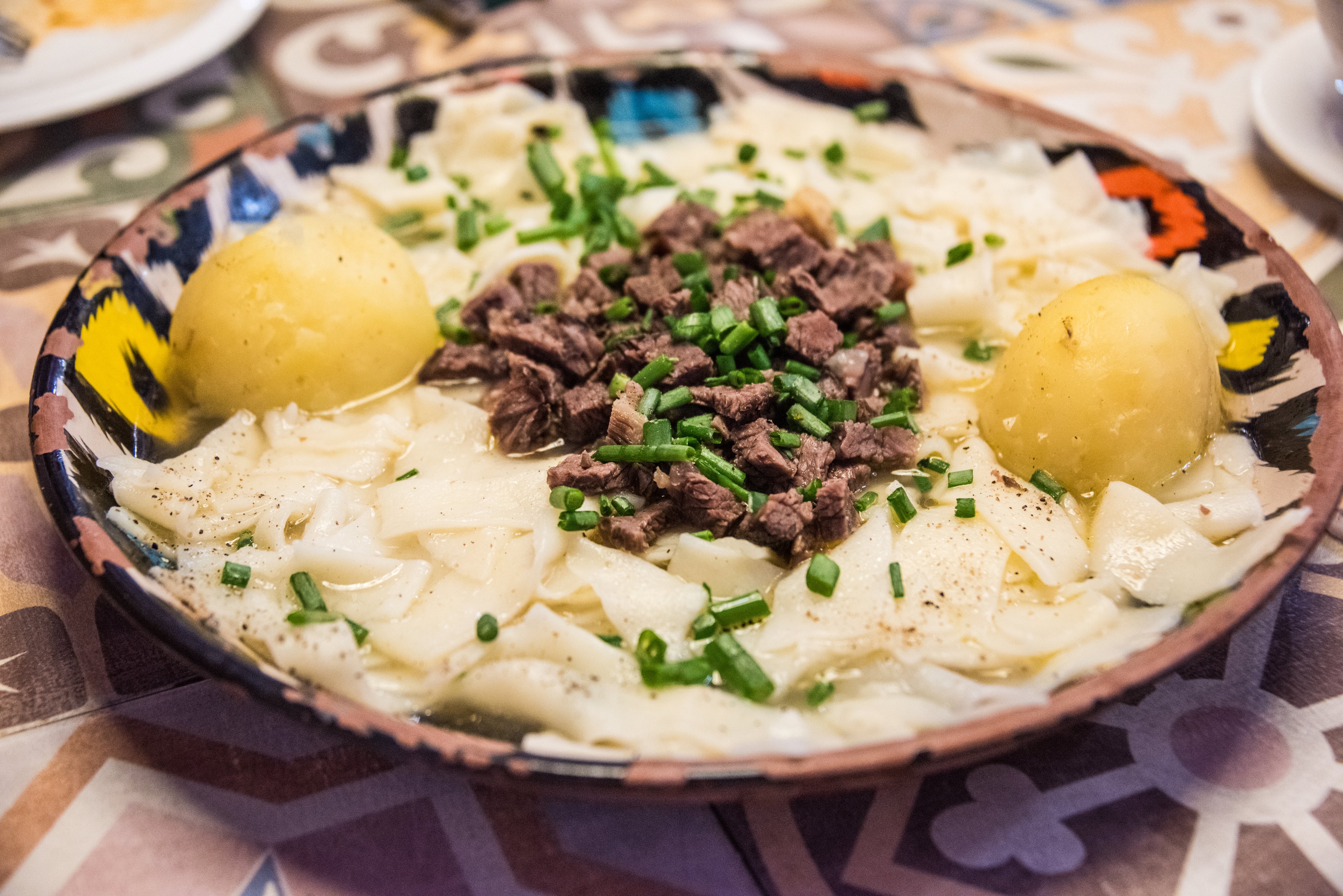 Bowl of beshbarmak with lamb and hand-cut noodles, Kyrgyzstan national dish
