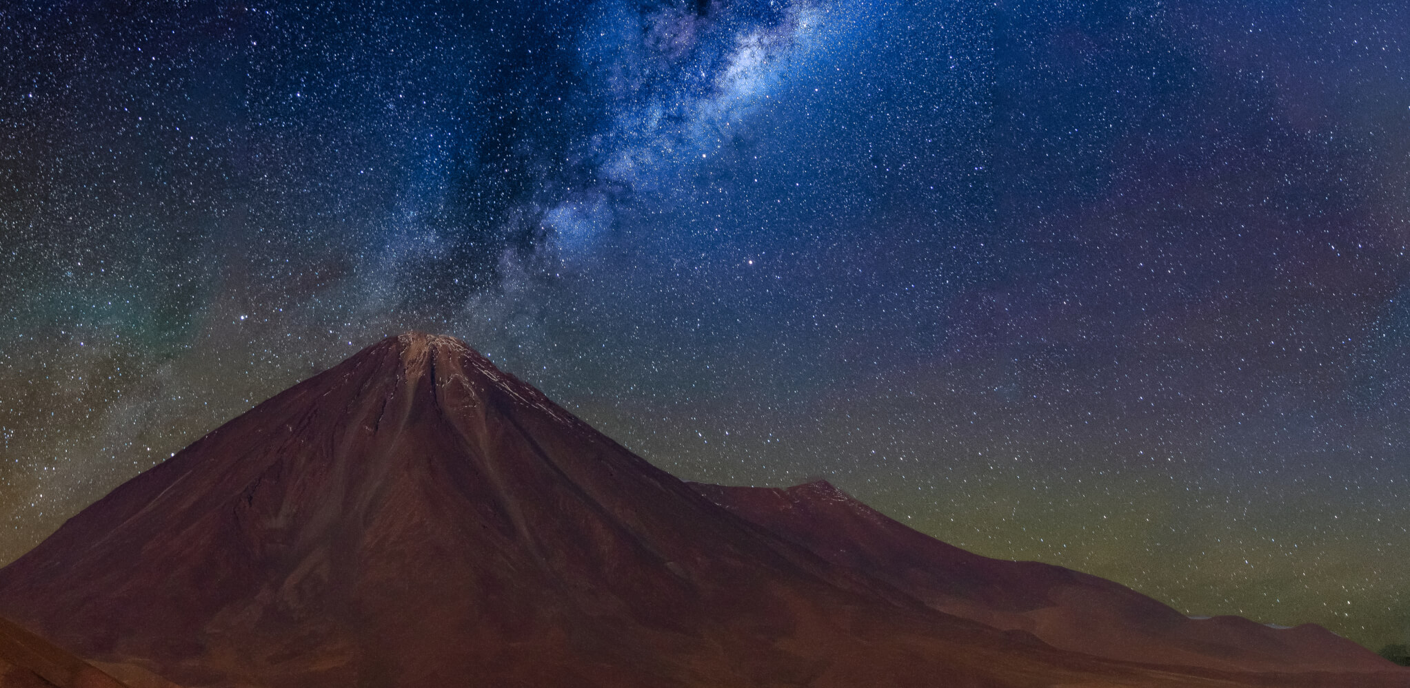 The Milky Way glows above Licancabur Volcano, a top spot for Atacama stargazing and astronomy tourism