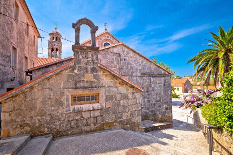 The historic stone square and church view of Blato on Korcula Island.
