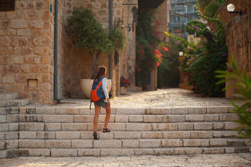 Tourist walking on the ancient stone streets of Old Jaffa in Tel Aviv, Israel