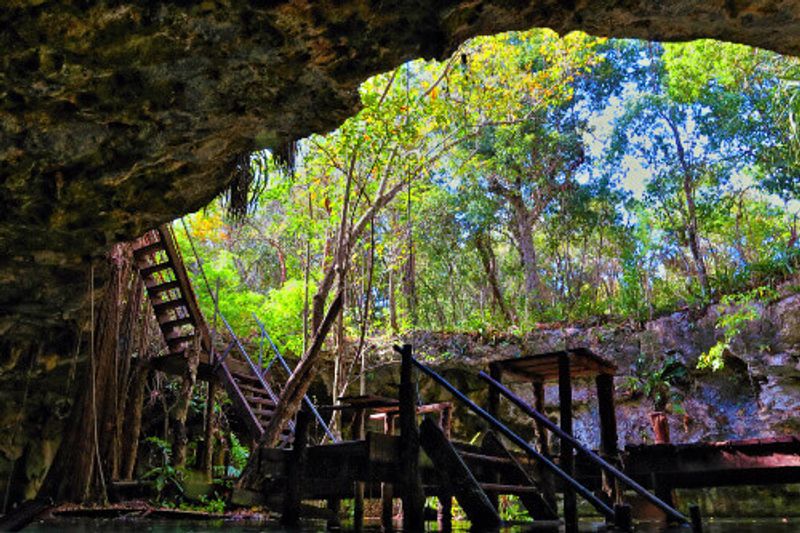 A wooden staircase in the cave entrance of Gran Cenote in Cancun.