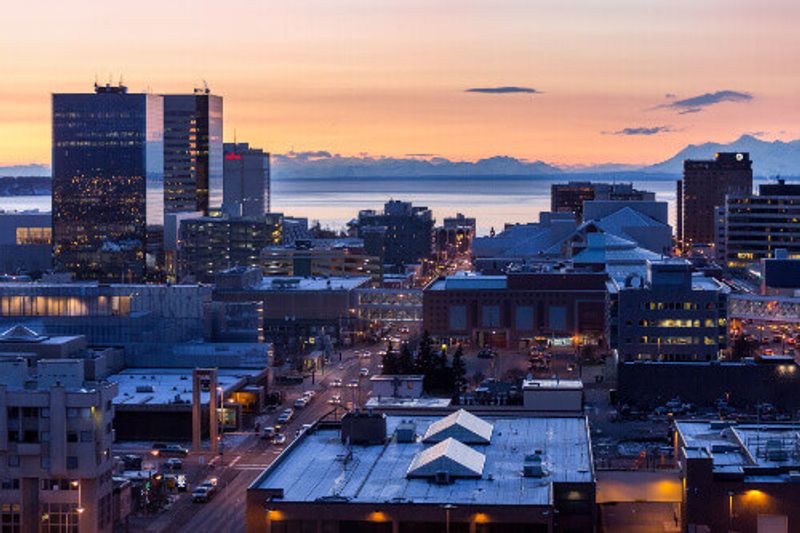A view of Downtown Anchorage city skyline at twilight, looking west towards Cook Inlet.
