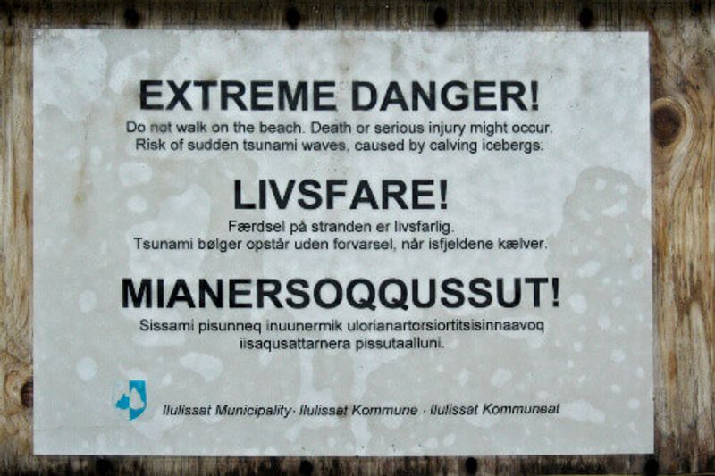 A sign on the boardwalk at Ilulissats icefjord warns of the dangers caused by calving icebergs.