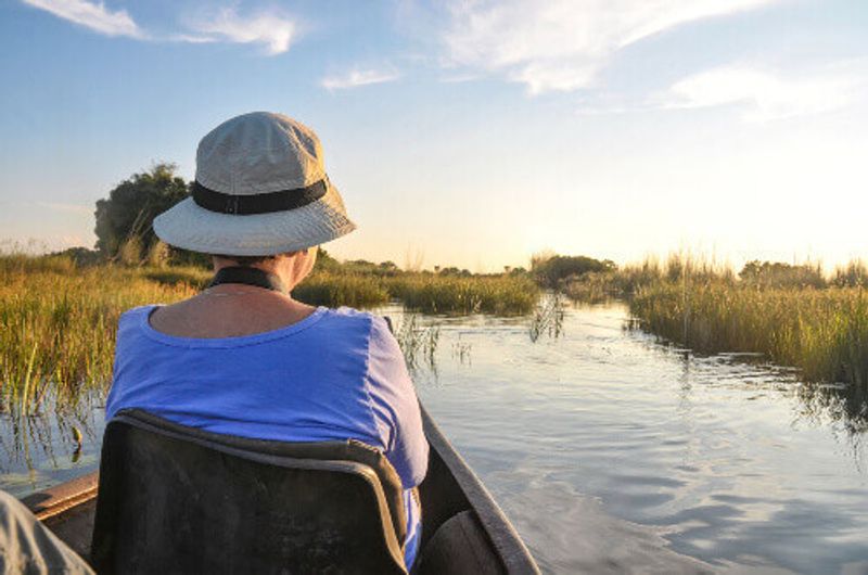 A tourist in the Mokoro Boat in the Okavango Delta.