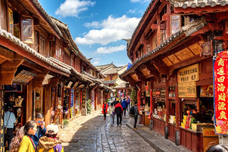 Tourists explore the old town of Lijiang.