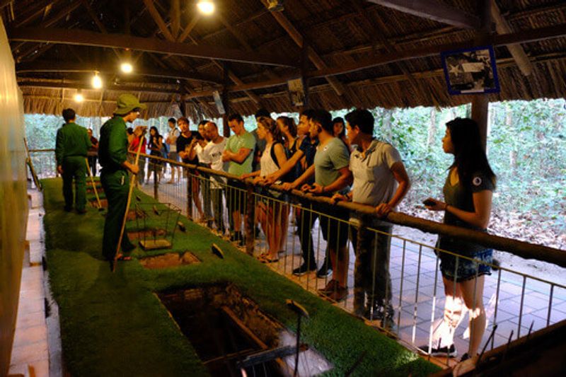 The local staff show how to use the trap in the Cu Chi tunnels.