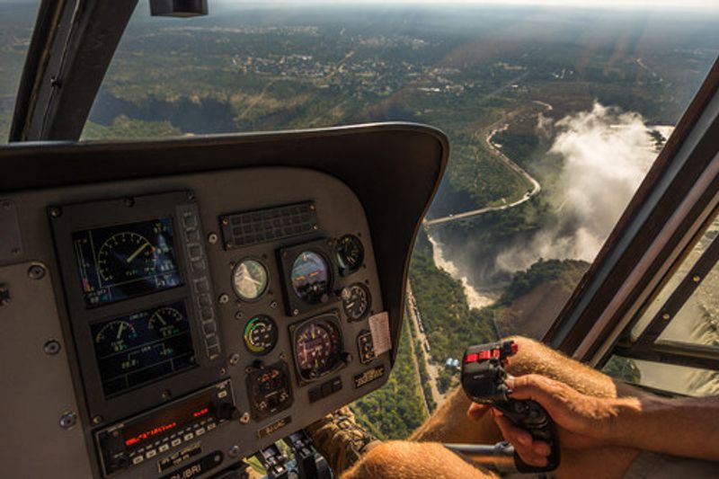 A helicopter flies over Victoria Falls.