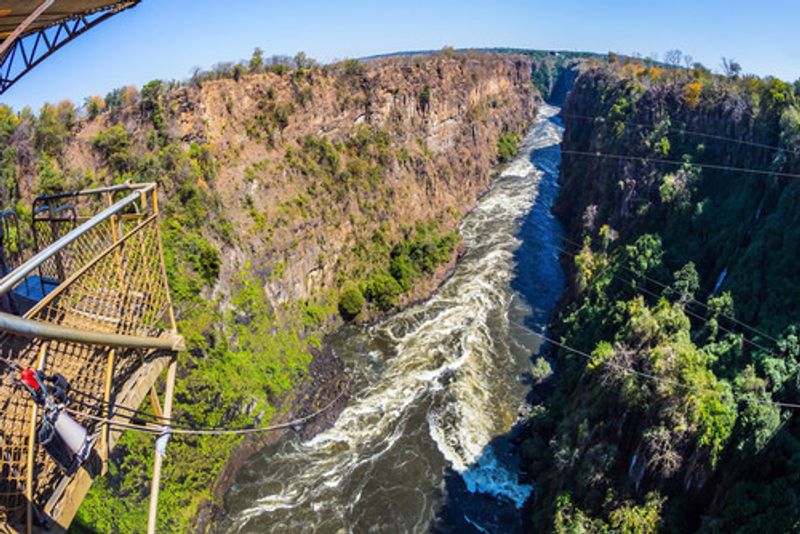 Adventurous people enjoy bungee jumping over Victoria Falls.