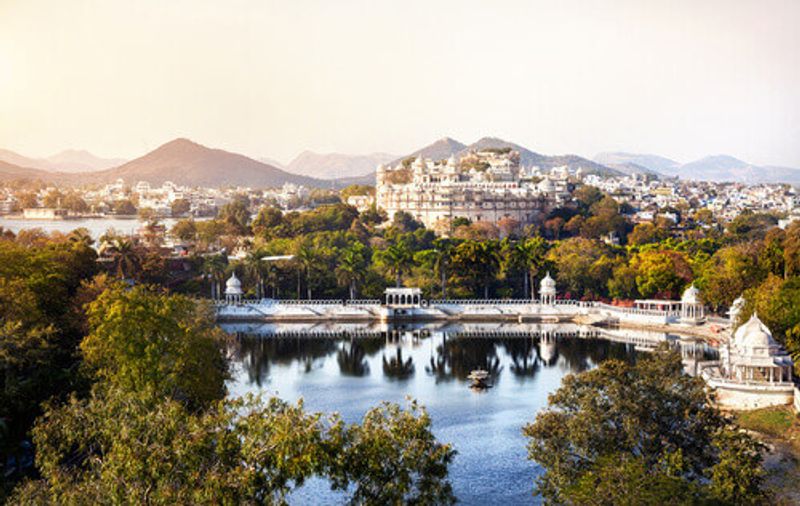 City Palace on Lake Pichola overlooking the Aravali Mountains in Udaipur.
