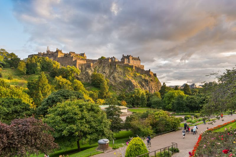 View of Edinburgh Castle during sunset at the Princess Street Gardens.