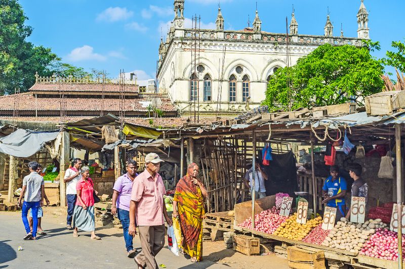 The Gothic Revival building with locals in Pettah.