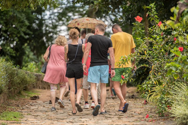 Tourists doing a group tour at the Handunugoda Tea Estate in Sri Lanka.