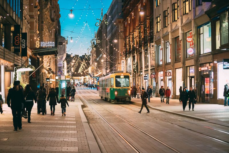 A passing tram at the busy Aleksanterinkatu street during winter