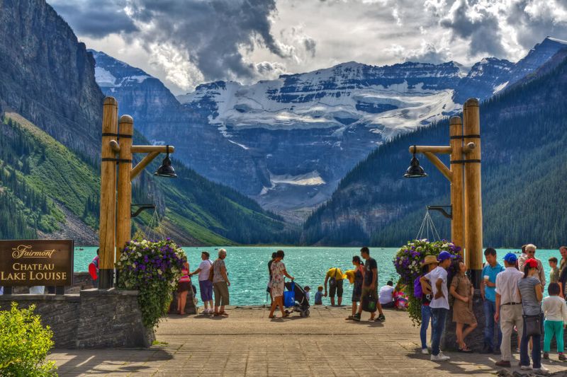 Visitors enjoy a view of the famous Lake Louise from the Fairmont Chateau Lake Louise Hotel.