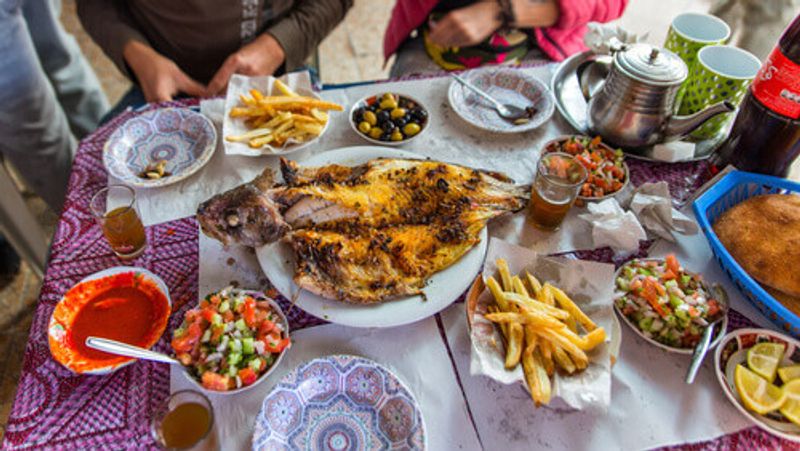 Dinner with fish and seafood served at the fish market in Essaouira.