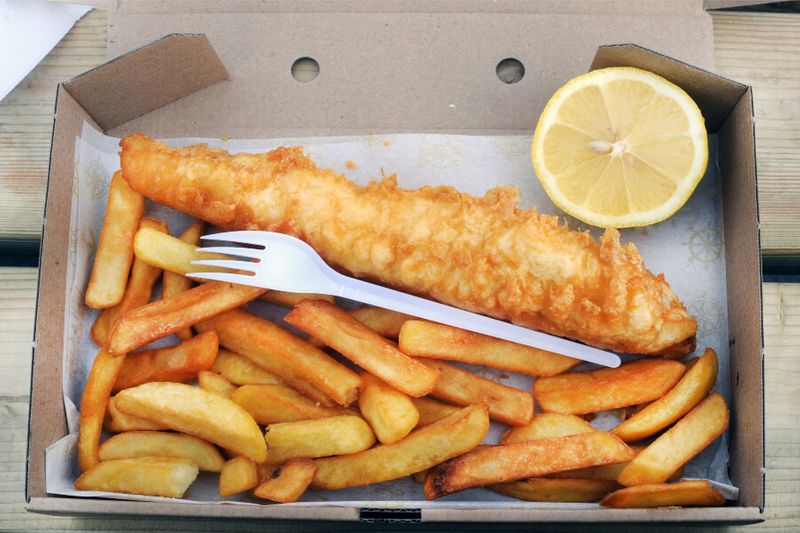 Tasty fish and chips on a table.