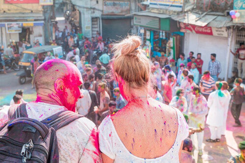 Visitors sit during the Holi Festival in India.