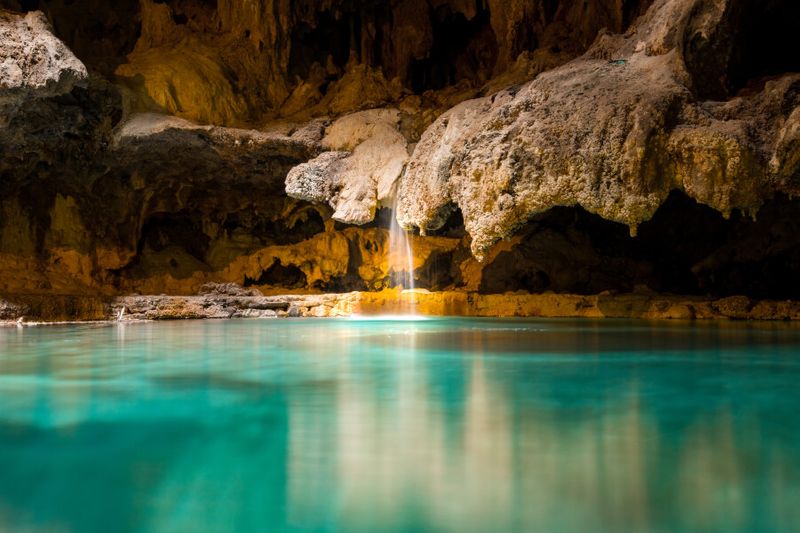 A picturesque small waterfall in the Rats Nest Cave in Canmore, Canada.