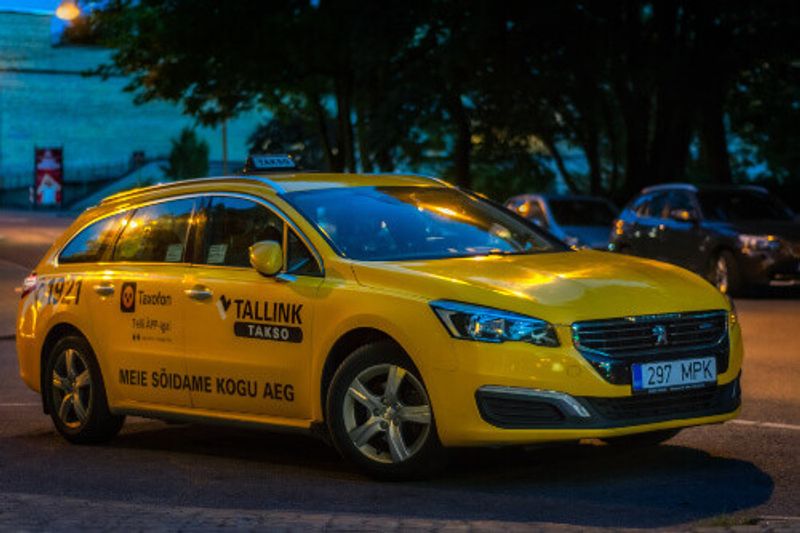 A yellow taxi in the late evening.