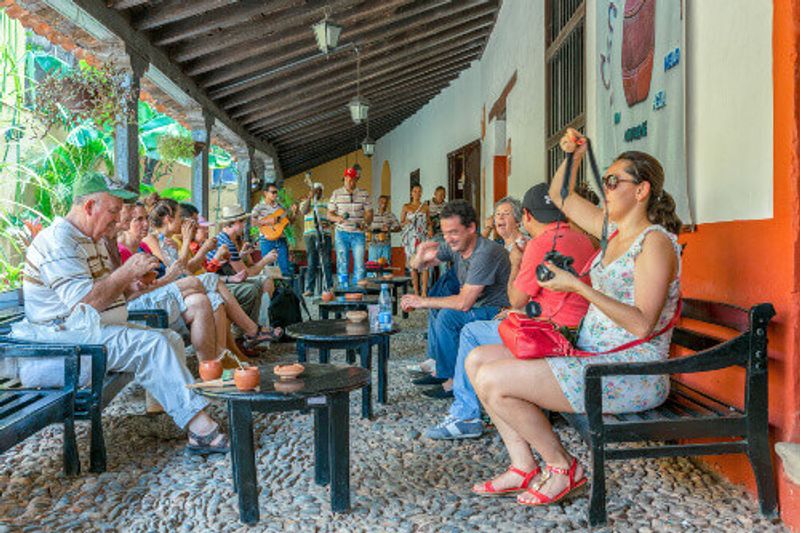 Drinking Canchanchara in La Canchanchara, a UNESCO World Heritage village in Trinidad.