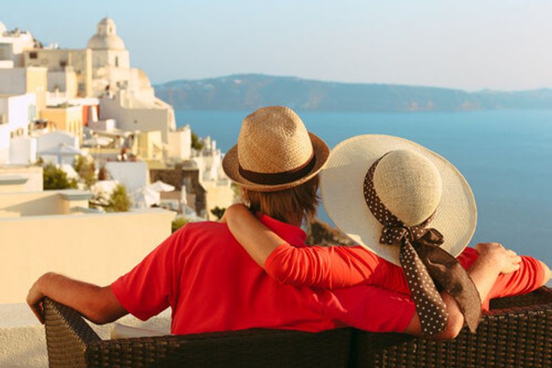 A couple enjoy the view of Santorini.