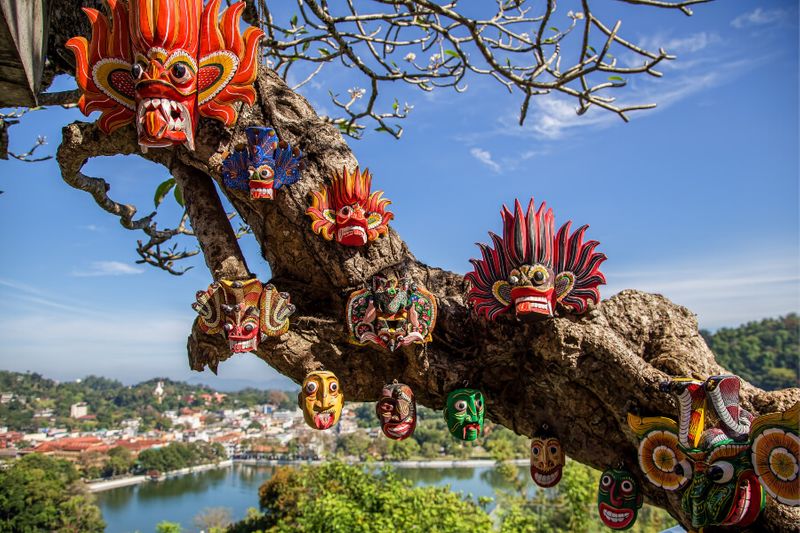 Masks are attached to a tree with the city in the background.