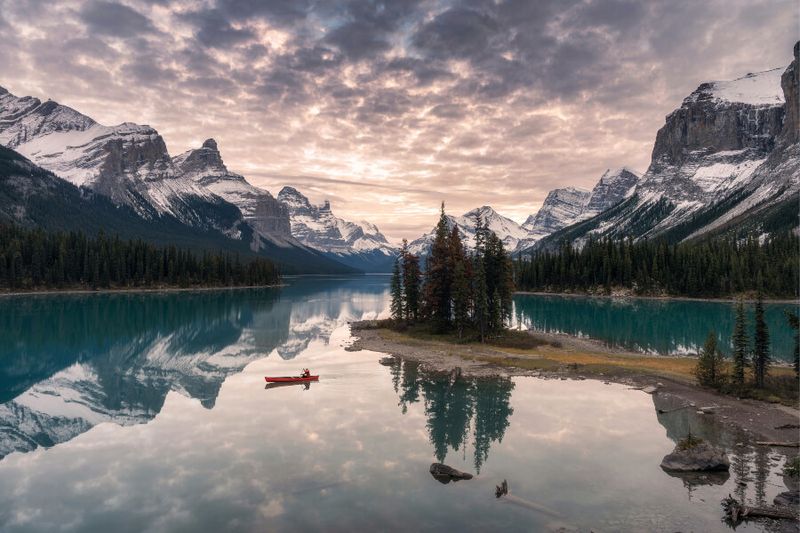 A tourist canoeing on Maligne Lake on Spirit Island in Jasper National Park.