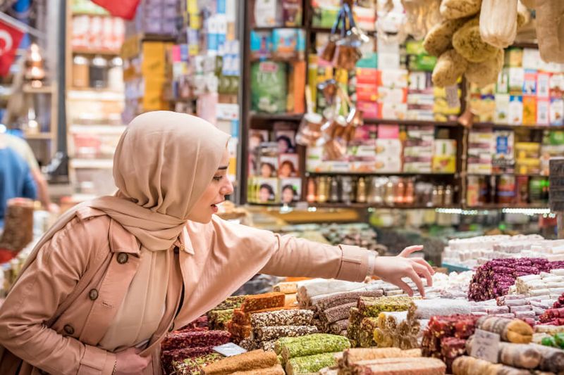 A female tourist wearing headscarf at a bazaar in Eminonu