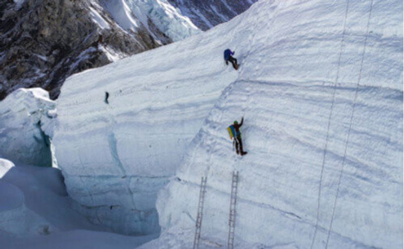 Visitors climb Mount Everest.