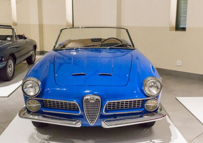 A vintage Alfa Romeo in spider blue at a motor vehicle exhibit in the Franschhoek Motor Museum.