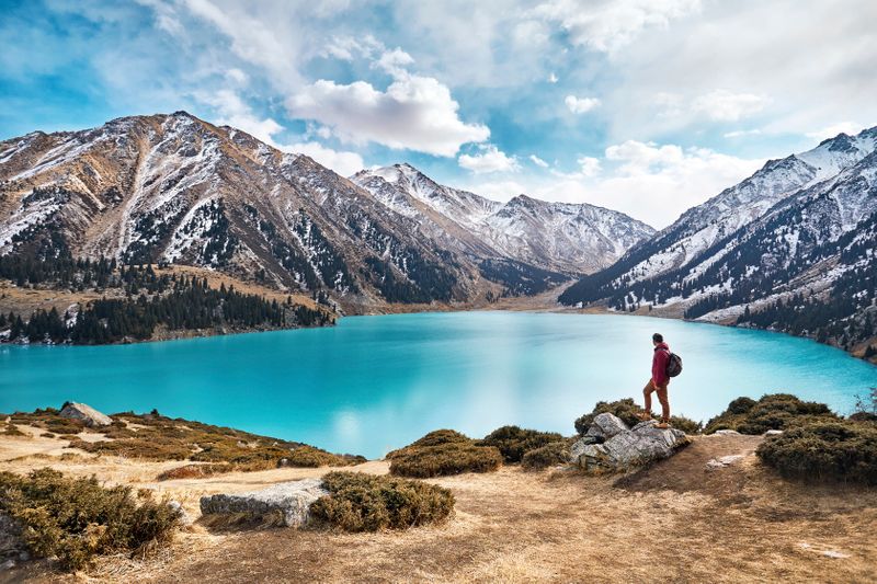 Turquoise Big Almaty Lake surrounded by snow-capped mountains, near Almaty city. 