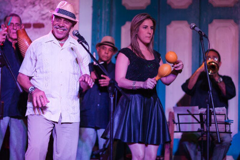 The Buena Vista Social Club artists performing for their audience at  Havana Club Rum Museum.