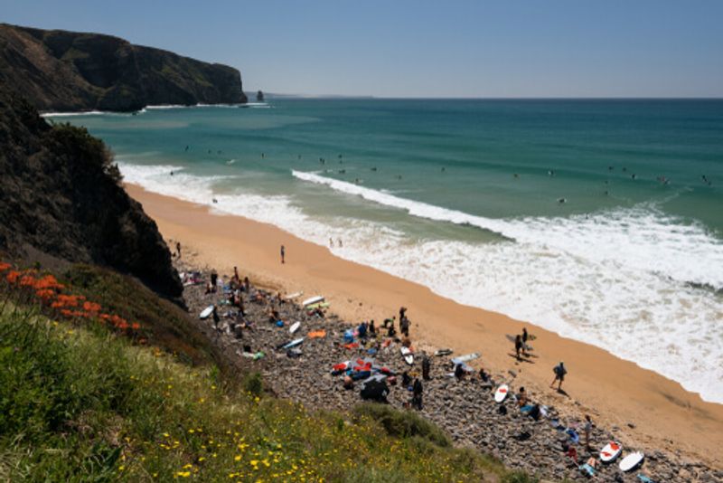 The relaxing Aljezur surf beach in Portugal welcomes tourists and locals alike.