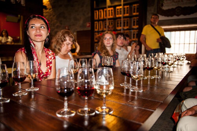 Visitors enjoy port wine tasting in Porto Portugal.