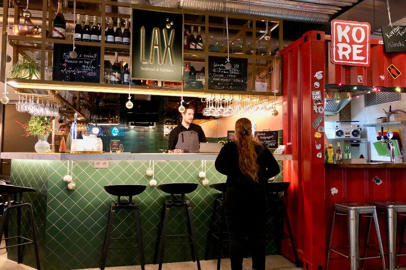 A female customer ordering food at Grandi Mathol,l a new streetfood market in Reykjavik.