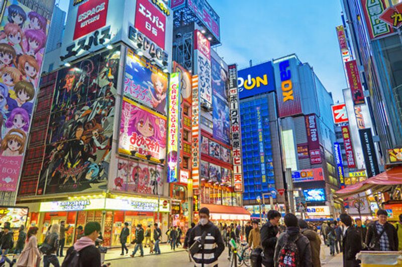 Beautiful building and lights with Japanese people at night in Akihabara, Tokyo.