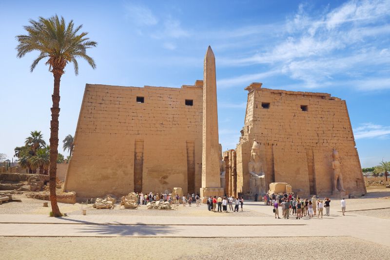 Entrance to Luxor Temple with tourists waiting to get in early in the morning