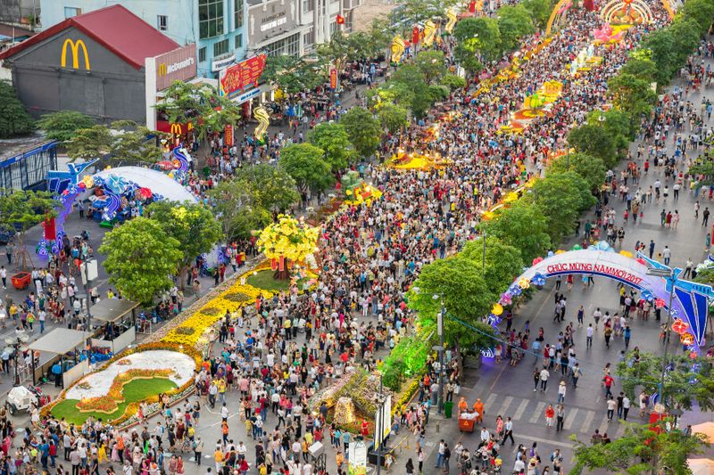 The crowded streets of downtown Ho Chi Minh lined with flowers during the Lunar New Year