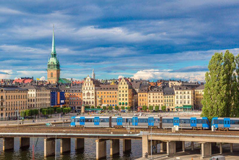 A train passes by the Stockholm skyline.