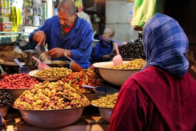 A woman purchases wares from a local market.