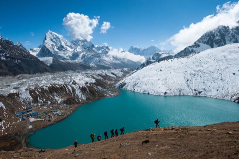 People hike alongside the Gokyo lakes region in Nepal.