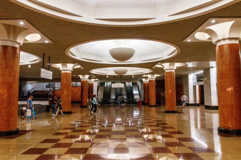 Passengers in the entrance and exit hall of the Park Pobedy Metro Station in Moscow.