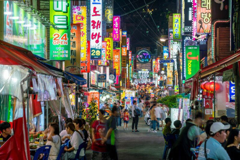 People on Pojangmacha eating and drinking at Nampo-dong street market in Busan South Korea