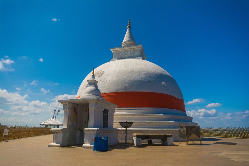 A traditional temple sits against the backdrop of Yala National Park.