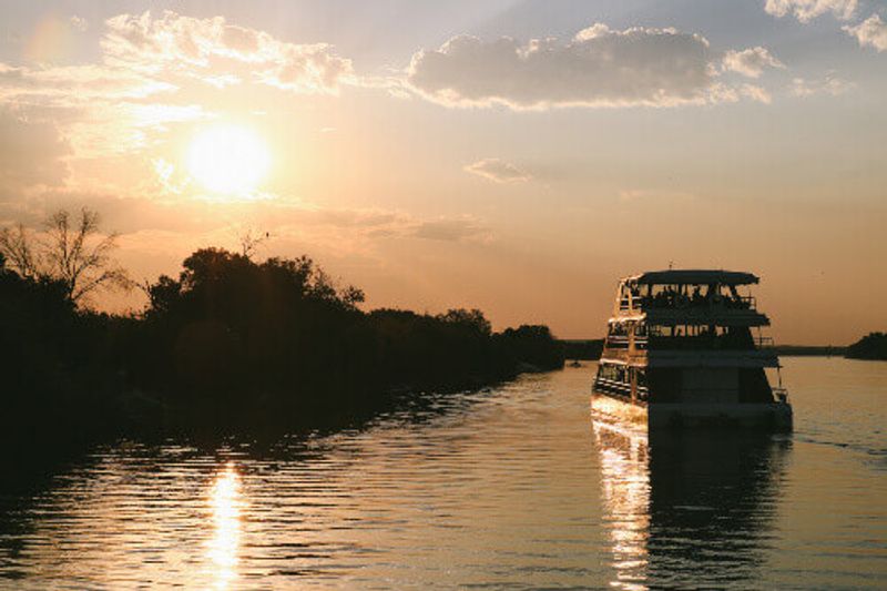 A serene sunset boat cruise near the Botswana side of the Zambezi River is an unmissable sight.