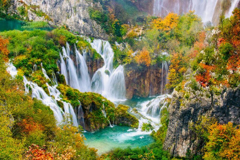 Detailed view of the beautiful waterfalls in the sunshine during autumn in Plitvice National Park.