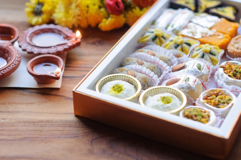 Indian sweets or mithai and oil lamps, or diyas